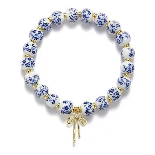 CHINOISERIE CHARM BRACELET WITH GOLD BOW